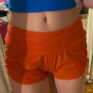 Red Lululemon speed up low rise shorts.